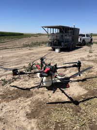 Grounded drone refilling on pesticide